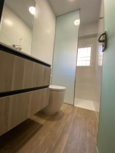 a bathroom with a toilet and a sink at Loft estilo industrial en playa de las marinas!!! in Denia