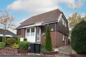 a red brick house with a black roof at Am Ganterhals 13 Wohnung 2 in Dahme