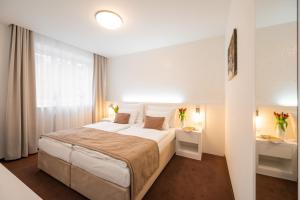 Postel nebo postele na pokoji v ubytování Hotel Vila Viola