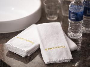 a table with two towels and a bottle of water at Shibuya Excel Hotel Tokyu in Tokyo