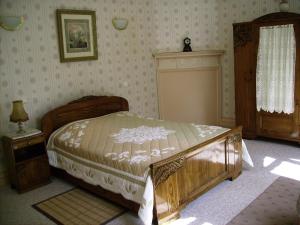 a bedroom with a bed and a table and a window at Chateau de la Garenne in Guînes