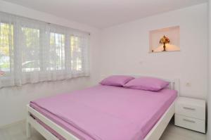 Postel nebo postele na pokoji v ubytování Apartments Tojčić