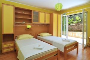Postel nebo postele na pokoji v ubytování Apartments Tojčić