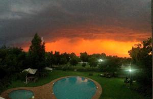 a view of a cloudy sky with a pool at night at Lido Hotel in Johannesburg
