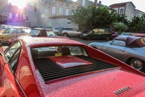 a red car with its hood open in a parking lot at Hostellerie Du Grand Saint Antoine in Albi