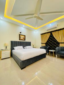 a bedroom with a bed and a ceiling fan at Continental boutique House in Islamabad