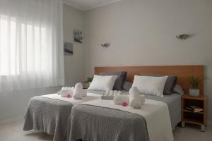 a hotel room with two beds and a table at Hotel Tolosa in Salou