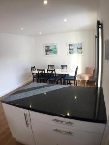 a kitchen and dining room with a table and chairs at Avocet House in Wells next the Sea
