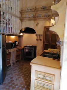 a kitchen with a sink and a stove top oven at château de Mauriac in Senouillac