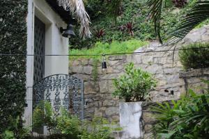 a door to a house with a stone wall at L'Homme de Rio Boutique Hotel in Rio de Janeiro