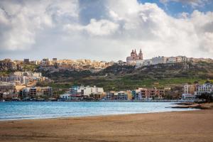 a view of a city from the beach at 123 MAINSTREET boutique hotel in St Julian's