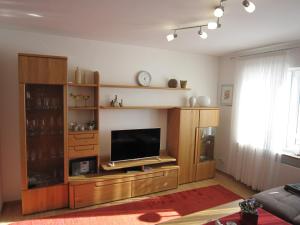 a living room with a large entertainment center with a flat screen tv at Ferienwohnung Luzia in Nettetal