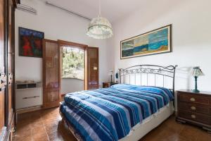 a bedroom with a bed and a dresser and a window at Trulli Serralta by BarbarHouse in Locorotondo