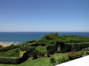 a view of a garden with the ocean in the background at Maison Bista Eder in Bidart +11 photos