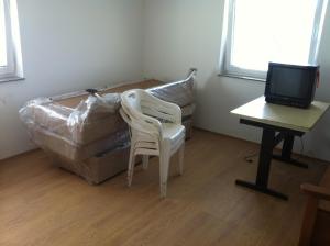 a room with a desk and a chair and a television at Apartments Baba Luce in Strica