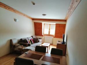 a living room with a couch and a table at Apartman 205 Aparthotel Vučko in Jahorina