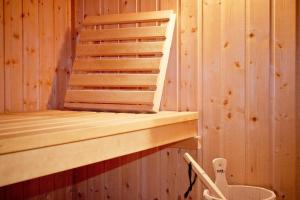 a wooden bunk bed in a wooden room at Hôtel Spa - Au Charme Rabelaisien in Amboise