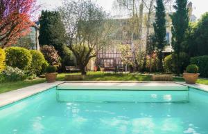 a swimming pool in the yard of a house at Hôtel Spa - Au Charme Rabelaisien in Amboise +109 photos
