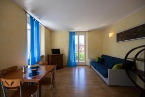 a living room with a blue couch and a table at Villa Bellaria in Riva del Garda
