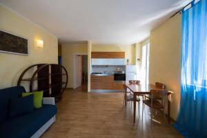 a living room with a table and a blue couch at Villa Bellaria in Riva del Garda
