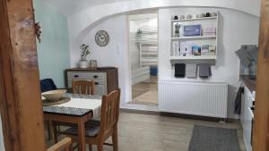 a kitchen with a table and a dining room at Várvölgy Vendégház - teljes ház, kizárólagos használattal in Veszprém