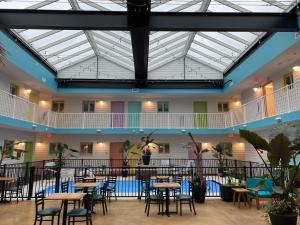 a large room with tables and chairs and a ceiling at Worthington of Logan in Logan