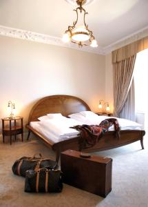 a bedroom with a large bed and a suitcase at Hotel Miramar in Westerland