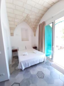 A bed or beds in a room at Case Vacanza In Antica Masseria