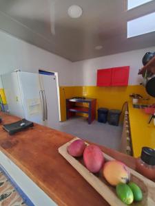 a kitchen counter with a cutting board with fruits on it at El Piropo in La Vega