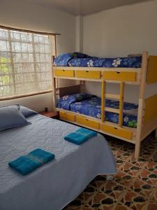 a bedroom with two bunk beds and a window at El Piropo in La Vega