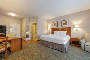 a hotel room with a bed and a desk and chair at Extended Stay America Suites - Bartlesville - Hwy 75 in Bartlesville