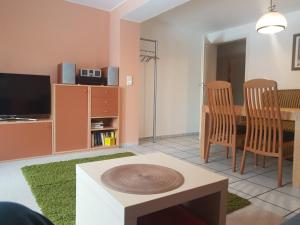 a living room with a table and a dining room at Ferienwohnung Granzow in Gaienhofen