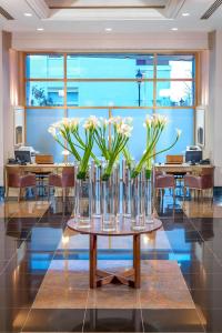 a group of vases filled with flowers on a table at The Chelsea Harbour Hotel and Spa in London