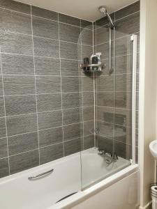 a shower with a glass door in a bathroom at Helena's Place (7 minutes walk to Nottingham Train station) in Nottingham