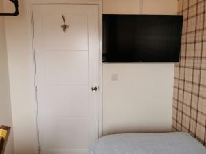 a white cabinet with a television on top of it at Helena's Place (7 minutes walk to Nottingham Train station) in Nottingham
