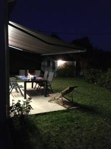 a table and chairs on a patio at night at Domaine de Praline maison de Fouesnant in Fouesnant