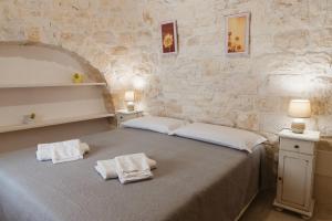 Postel nebo postele na pokoji v ubytování Trulli Loco + 37 fotografií