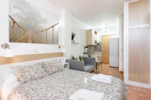 a bedroom with a bed and a bridge painting on the wall at Apartamentos Ohana - Edificio Tonillo in Los Cristianos