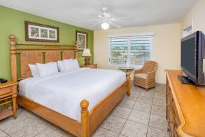a bedroom with a bed and a flat screen tv at Marina Del Mar Resort and Marina in Key Largo