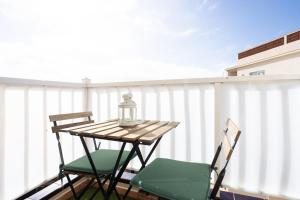 a table and two chairs on a balcony at Apartamentos Ohana - Edificio Tonillo in Los Cristianos