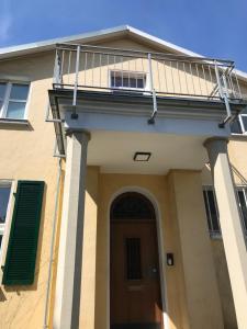 a house with a balcony on top of it at Haus Berlin in Hagen