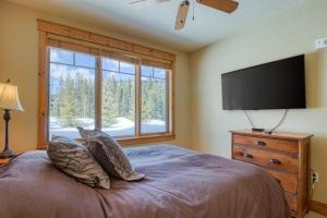 a bedroom with a large bed and a flat screen tv at Private Family Friendly 2 Bedroom Townhome Located In East Keystone With Access To Free Shuttle Service in Keystone