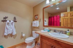 a bathroom with a sink and a toilet and a mirror at Private Family Friendly 2 Bedroom Townhome Located In East Keystone With Access To Free Shuttle Service in Keystone +14 photos