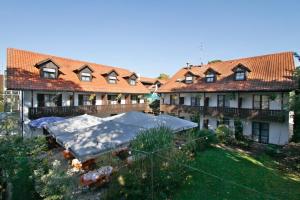 ein großes Haus mit Garten davor in der Unterkunft Hotel Neumayr in München