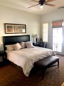 a bedroom with a large bed with a ceiling fan at Beautiful Casita, La Quinta Legacy Villas Resort in La Quinta