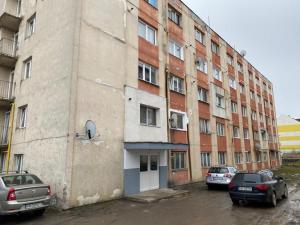 an old building with cars parked in front of it at Hidden Apartment in Miercurea-Ciuc