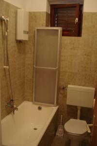 a bathroom with a tub and a toilet and a sink at Ancila in Brna +10 photos