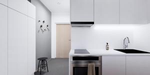 a white kitchen with a sink and a stove at New and cozy apartment in the centrum of Oulu in Oulu