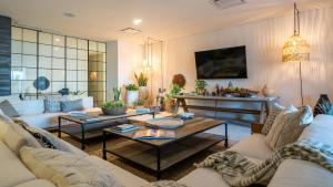 a living room with couches and a table at 1 Homes Preview Cabo in Cabo San Lucas