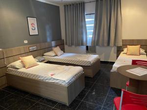 Ein Bett oder Betten in einem Zimmer der Unterkunft Belém Hotel